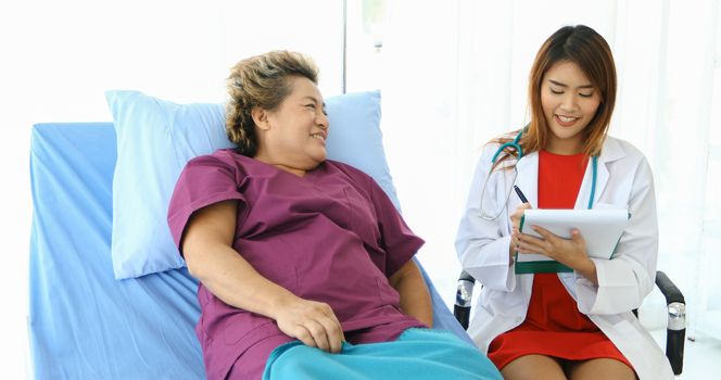 Doctor meeting and explaining medication to old woman patient at Hospitals