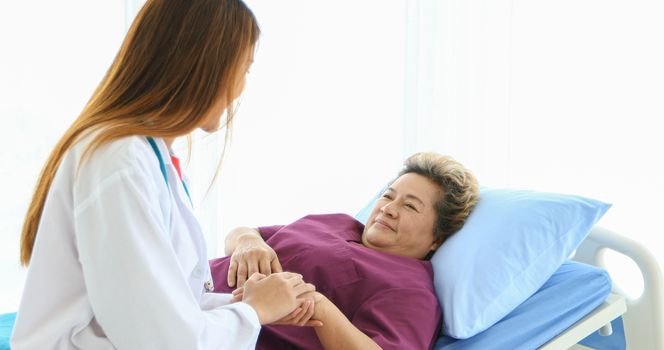 Doctor meeting and explaining medication to old woman patient at Hospitals