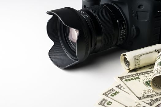 A black digital camera on banknotes with white background.