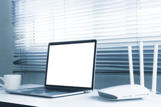 Blank screen laptop computer and router device on the table