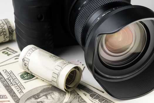 Close up of a black digital camera on banknotes with white background.