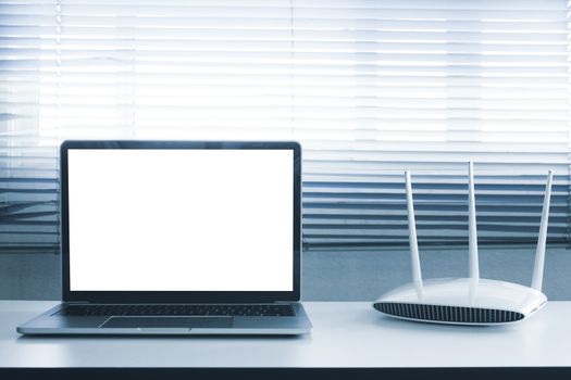 Blank screen laptop computer and router device on the table