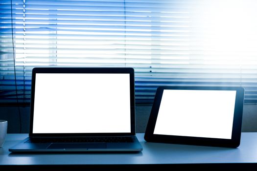Blank screen laptop and tablet computer on the table