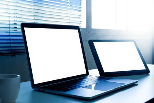 Blank screen laptop and tablet computer on the table