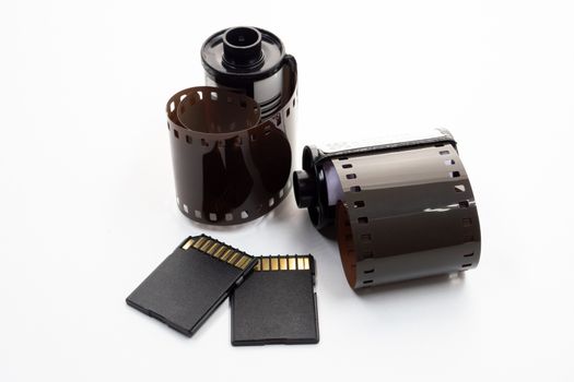 Film rolls and digital memory cards on a white background.