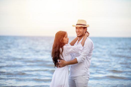 Happy Romantic Couples lover holding hands together walking on the beach