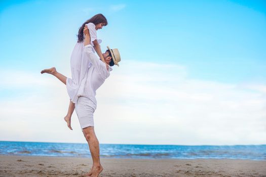 Happy Romantic Couples lover holding hands together walking on the beach