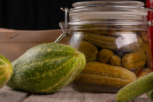 cucumber tomatoes cherry tomato jam canned corinichons on wooden background in studio