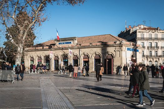 Montpellier, France - January 2, 2019: architectural detail of the city s tourist office (office de tourisme) on the Place de la Comedie where people pass on a winter day