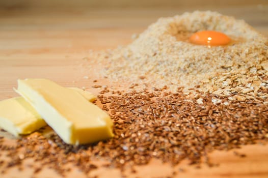 Ingredients for baking a millet cake against a wooden background