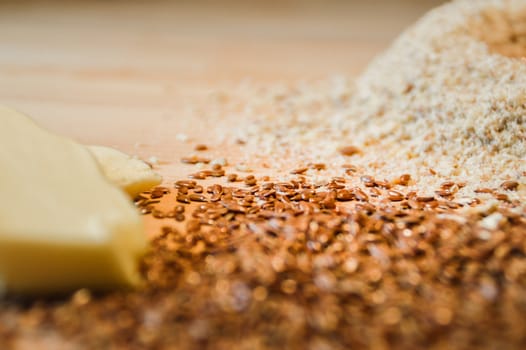 Ingredients for baking a millet cake against a wooden background