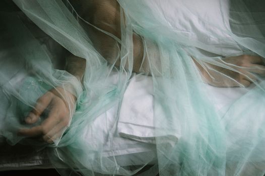 Conceptual photo of a man's hand covered in a veil