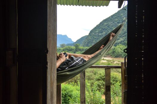 Relaxing in a hammock at Muang Ngoy Village in Laos