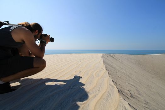 A man taking photos of the desert in Phan ri cua, Vietnam