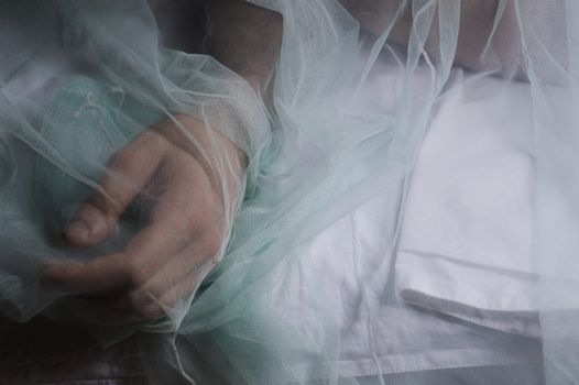 Conceptual photo of a man's hand covered in a veil
