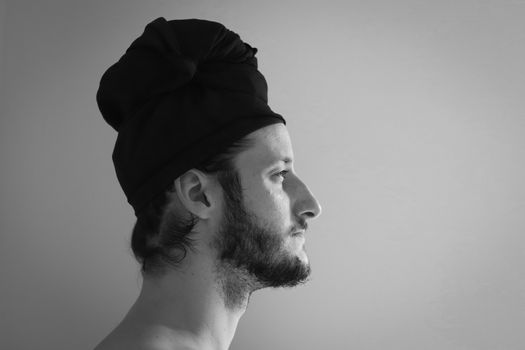 Side view of an attractive man wearing a turban, shot in black and white