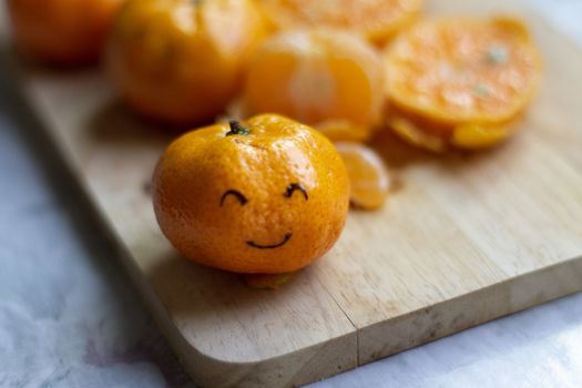 Conceptual photo showing an orange with a smiley face to show the concept of happiness, choosing happiness, positivity and mental health