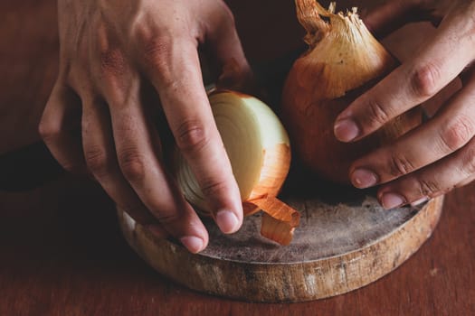 Close up of hands holding fresh white onion bulbs