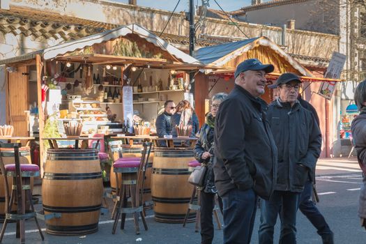 Marseillan, France - December 30, 2018: Street atmosphere in the Christmas market of the city where people walk on a winter day