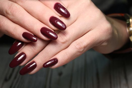 Closeup photo of a beautiful female hands with elegant manicure and diamond rings.