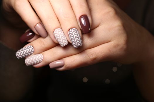 Closeup photo of a beautiful female hands with elegant manicure and diamond rings.