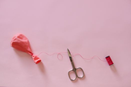 Plastic Balloon and Scissors showing concept of Plastic Use Reduction