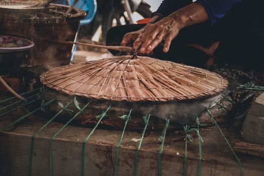 Traditional Banh Trang or rice paper making in Nhon Hoa rice paper village of Vietnam that is both a livelihood and cultural tourist attraction