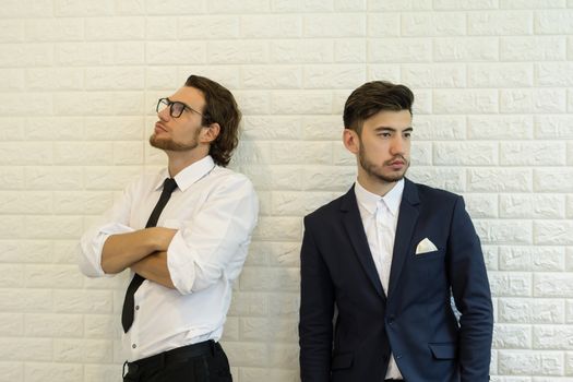 Two businessmen standing in office.