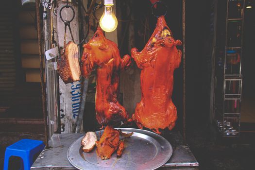 Cantonese style suckling pig roast, a popular street food in Old Quarter or French Quarter of Hanoi, Vietnam