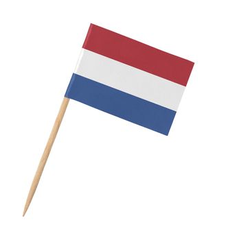 Small paper dutch flag on wooden stick, isolated on white