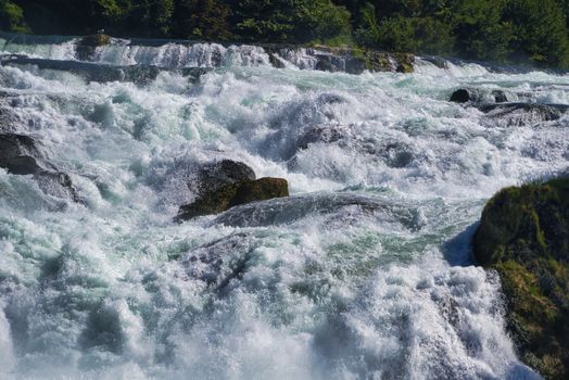 the famous rhine falls in the swiss near the city of Schaffhausen - sunny day and blue sky