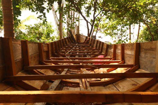 A traditional Cambodian or Khmer boat called Bon Om Touk being repaired in an island village of Koh Rong