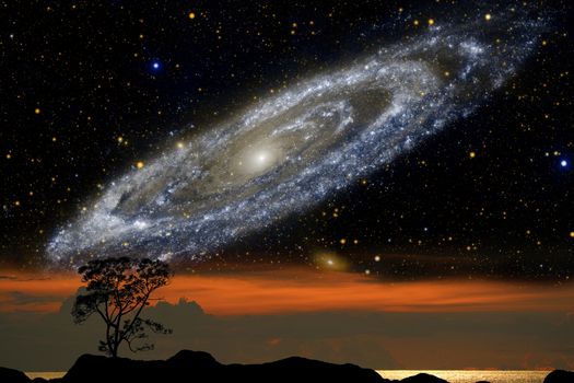 silhouette tree on mountain and nebula galaxy over the sunset sky, Elements of this image furnished by NASA