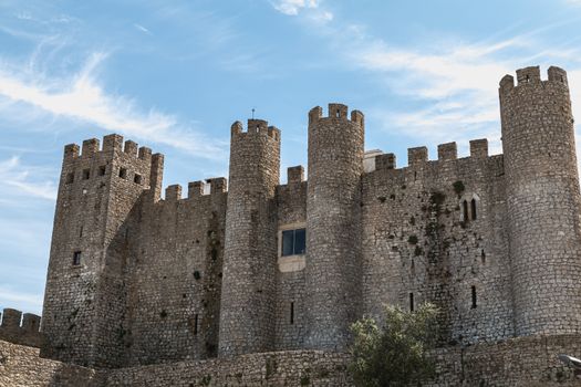 Obidos, Portugal - April 12, 2019: architectural detail of the medieval castle of Obidos on a spring day