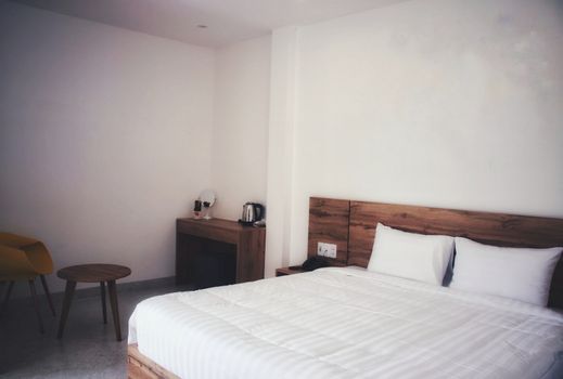 Clean and simple white bedroom with a double bed