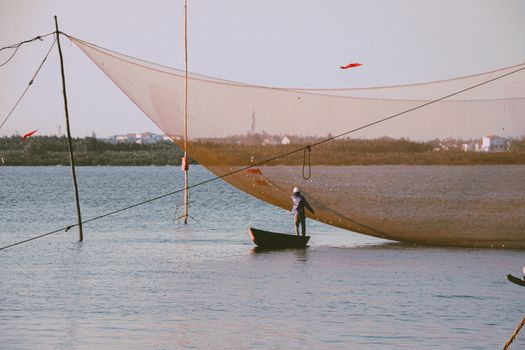 A fisherman setting up the stationary lift nets or lift nets, a traditional Vietnamese method of fishing