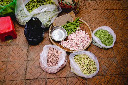 Beans and peas sold in the traditional local street market in Danang Vietnam that shows the authentic lifestyle and local culture of the country