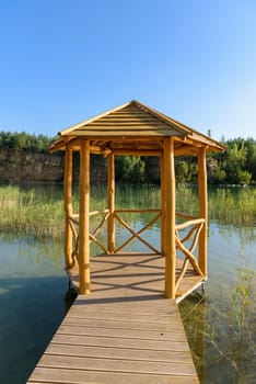 Wooden bower on the pond in an old quarry in Grodek park in Jaworzno