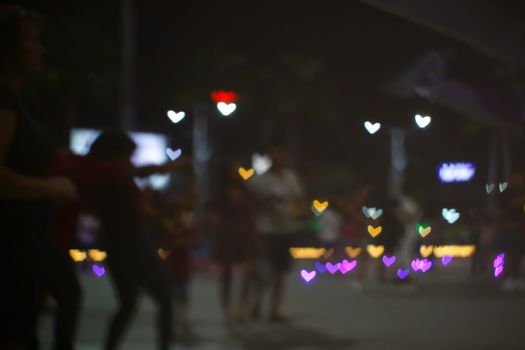 blur people buy heart shape love valentine's day colorful object on night light of shopping mall