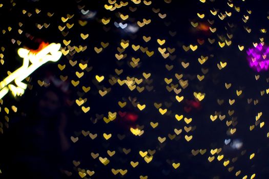 bokeh and blur abstract heart shape love valentine colorful decorate night light on wall at shopping mall