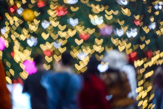 blur people selfie with heart shape love valentine colorful night light of shopping mall