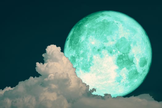 green strawberry moon back on silhouette heap cloud on night sky, Elements of this image furnished by NASA