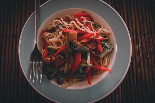 Top view of vegan pasta dish shot in low light