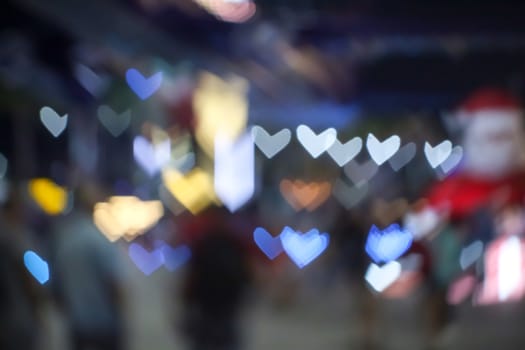 abstract blur and bokeh heart shape love valentine colorful night light of shopping mall
