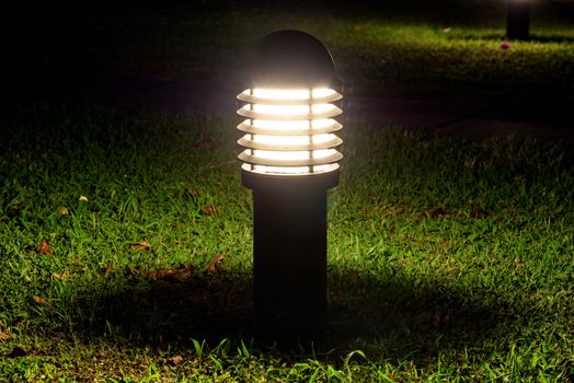 Closeup of glowing garden lamp in the dark