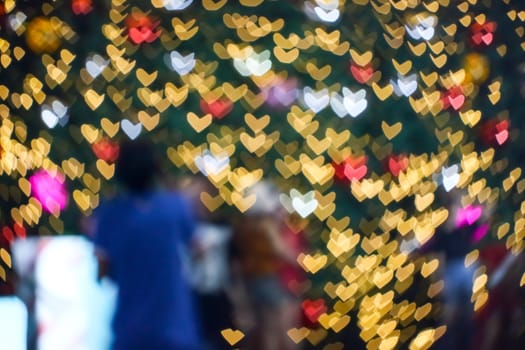 blur people selfie with heart shape love valentine colorful night light of shopping mall