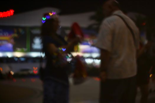 blur people buy heart shape love valentine's day colorful object on night light of shopping mall