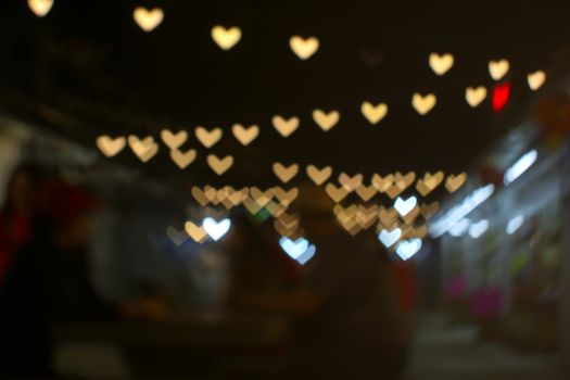 imgae of bokeh and blur line heart shape love valentine day night light in the garden vintage tone