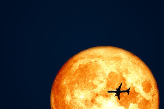 Full Crow Blood Moon and silhouette airplane flight on night sky, Elements of this image furnished by NASA