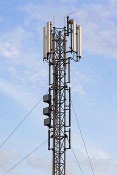 Cellular base station with panel antennas against blue sky